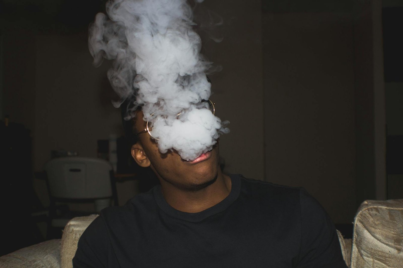 https://www.pexels.com/photo/man-wearing-black-crew-neck-blowing-smoke-1406559/